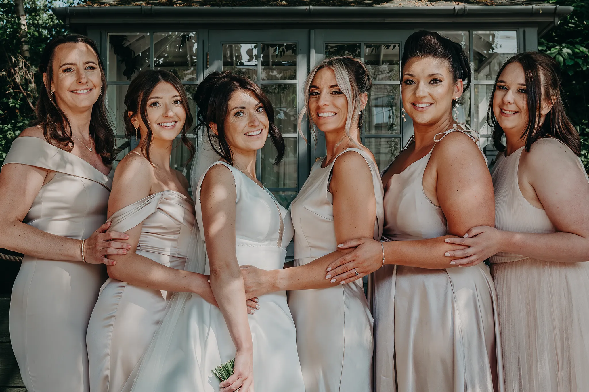 Bride posing with bridesmaids 