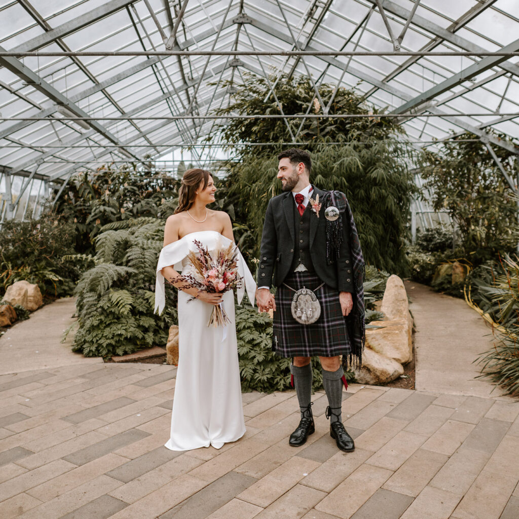 Wedding Photoshoot at Edinburgh Saughton Park, Edinburgh Wedding photography, Bride and gore holding hands
