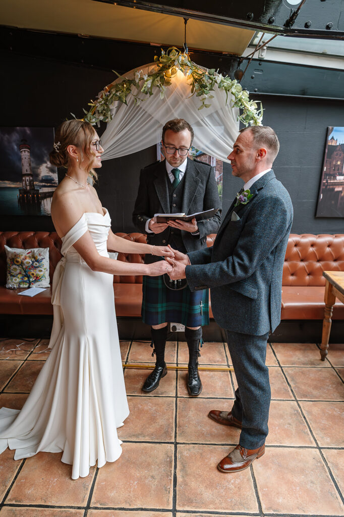 Couple standing with their celebrant during a small wedding ceremony in Edinburgh