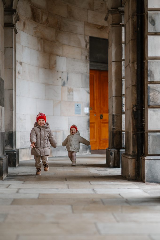 Young children exploring the city during a relaxed Edinburgh family photoshoot