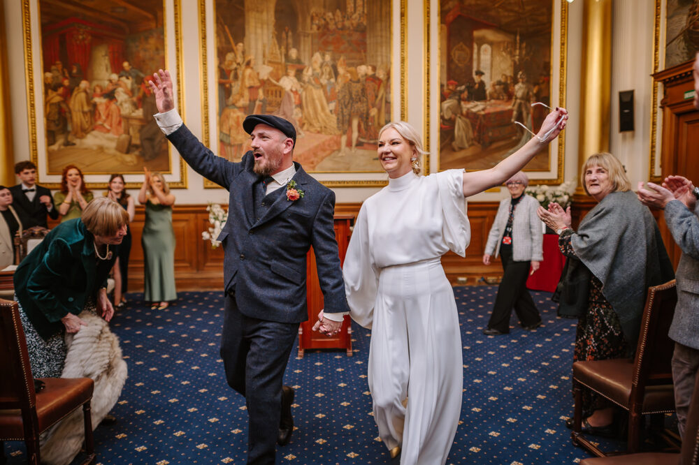 Steph and Keith celebrating after their wedding ceremony at Edinburgh City Chambers