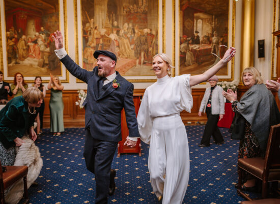 Steph and Keith celebrating after their wedding ceremony at Edinburgh City Chambers