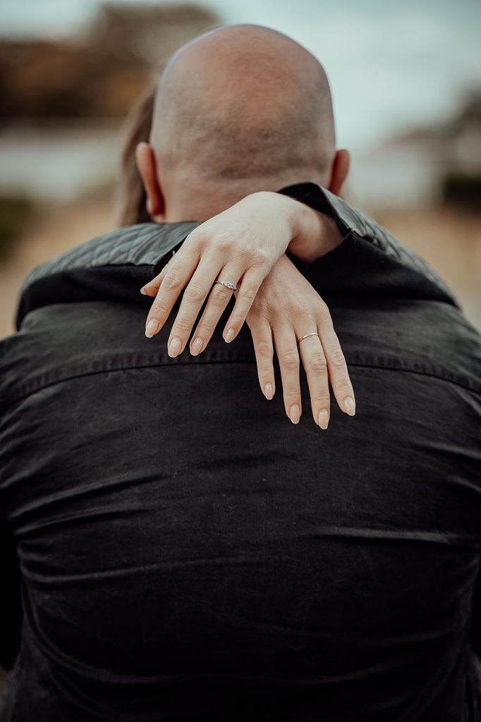 Engagement ring visible as Jenna embraces Mike during their Edinburgh photoshoot