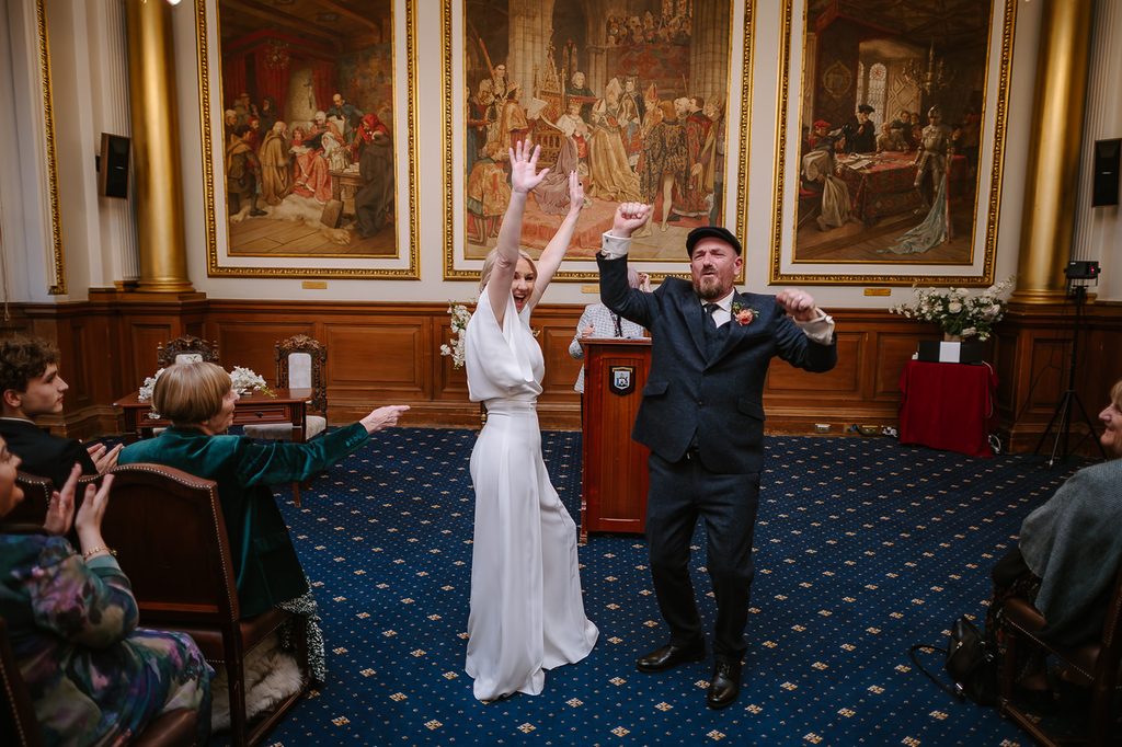 Steph and Keith celebrating after getting married at Edinburgh City Chambers
