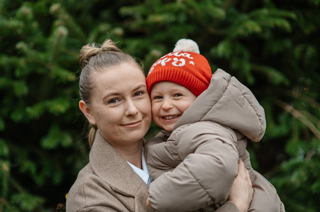 Mother holding her young child during a winter family photoshoot in Edinburgh