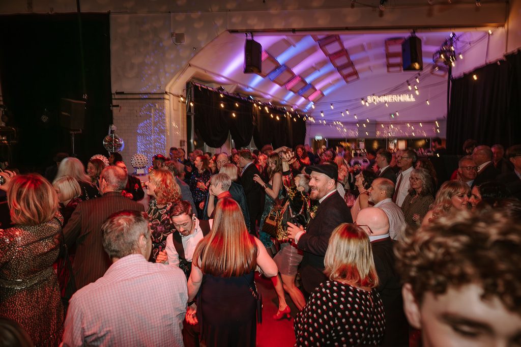 Guests celebrating on the dance floor at a Summerhall wedding in Edinburgh
