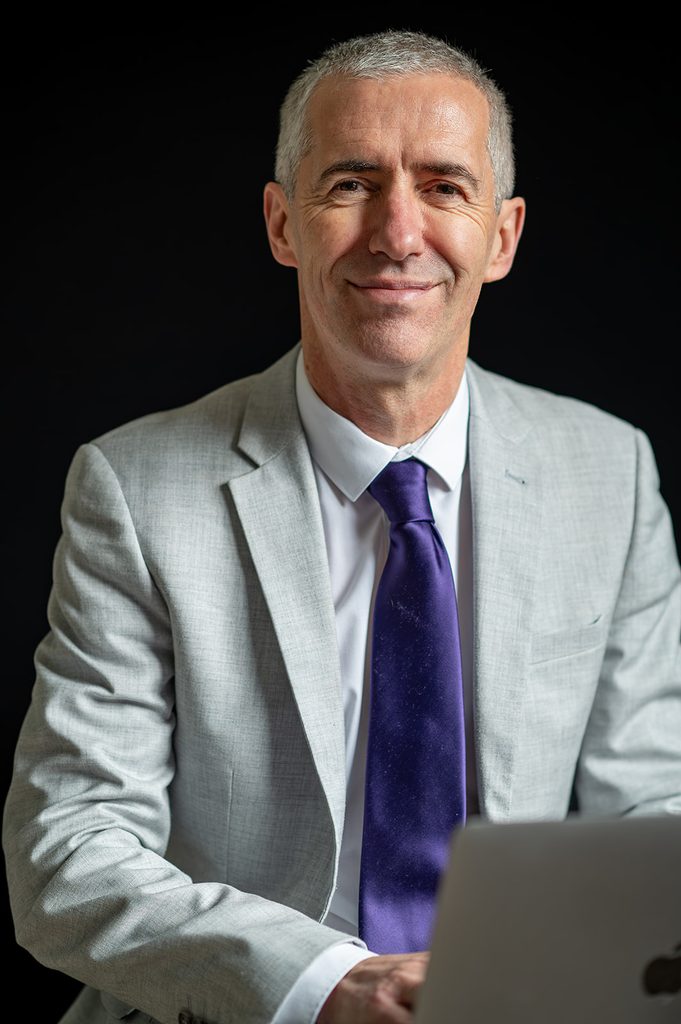 Formal corporate headshot of a professional wearing a grey suit in Edinburgh