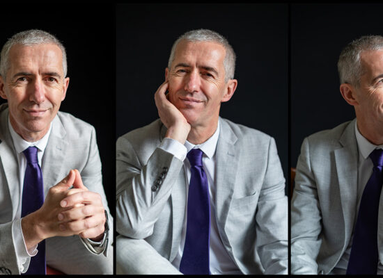 Professional corporate headshot photographed against a light background in Edinburgh
